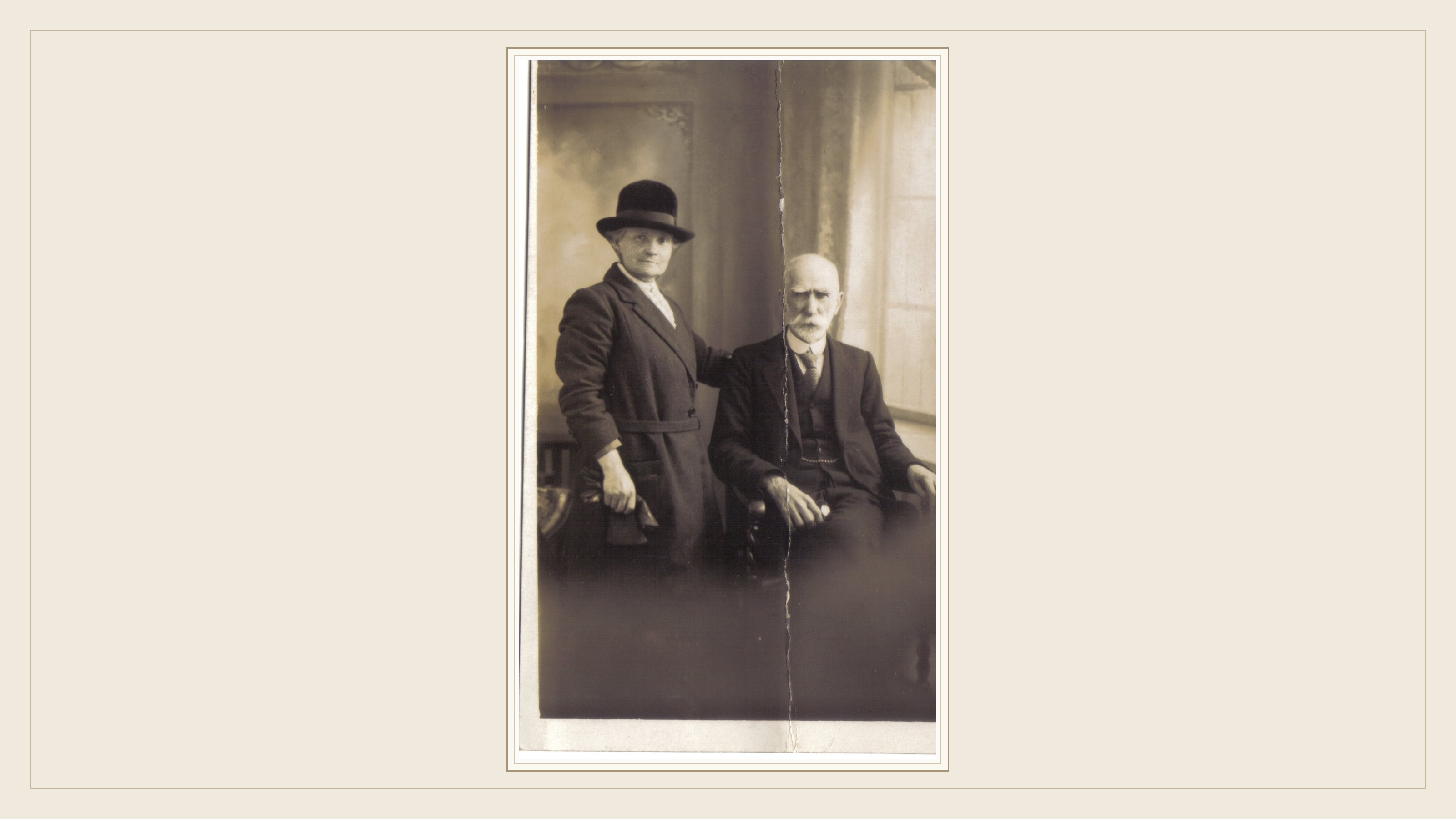 Thomas Davies (1864–1930) seated beside his wife Mary Davies in an original sepia family photograph, fully preserved inside a cream archival display frame.